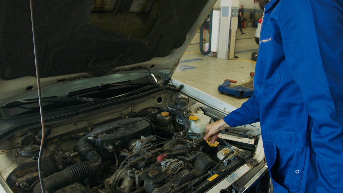 Technician checking AC components during Raleigh summer service